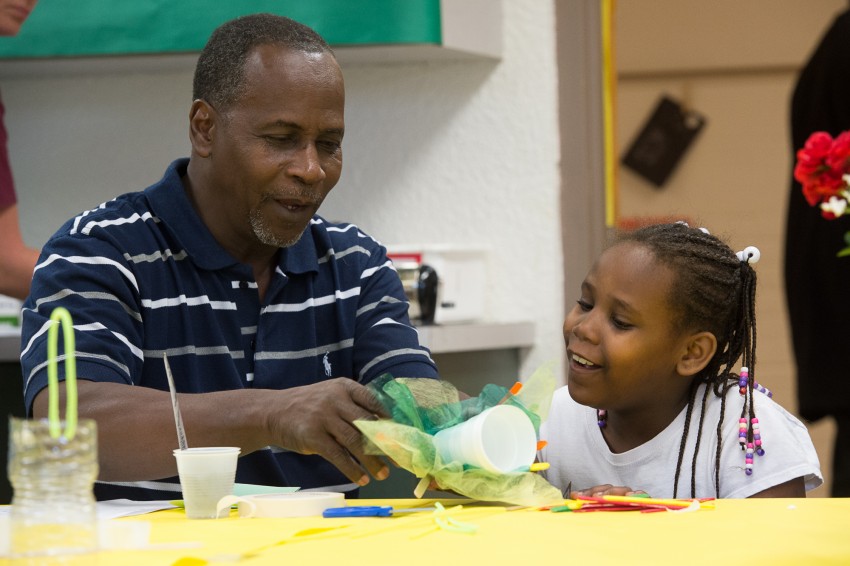 James Dean helps his daughter second grader Rudy Dean make a bird feeder during family literacy night at Lincoln Park Primary School in Pensacola, Fl. Thursday, April 23, 2015. (Michael Spooneybarger/ Pensacola Today)