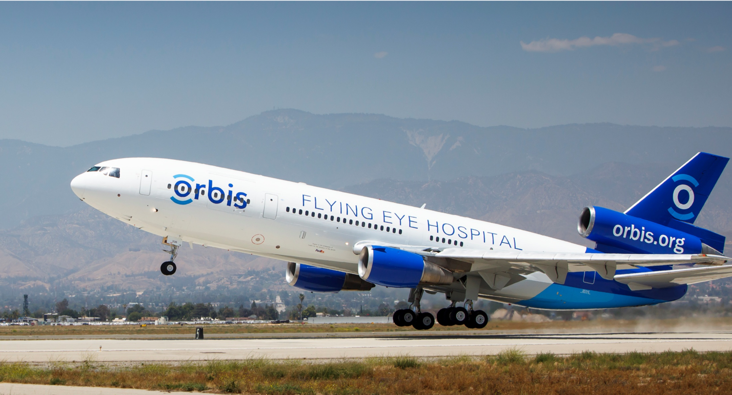 Image of a plane with the Orbis logo
