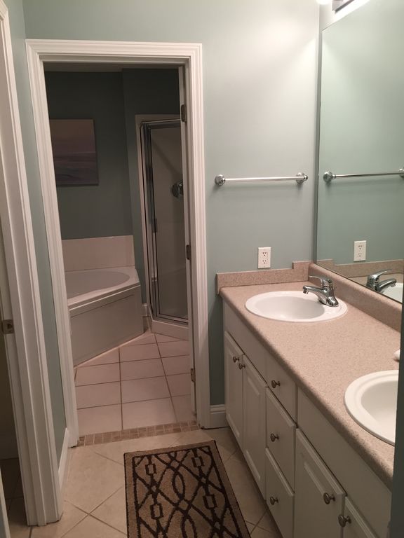 Master Dressing Area with walk in closet has jacuzzi tub and glass shower