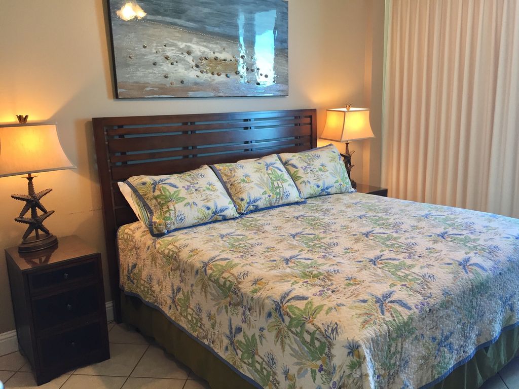 Comfortable King bed in master bedroom opens to gulf front balcony at Lighthouse