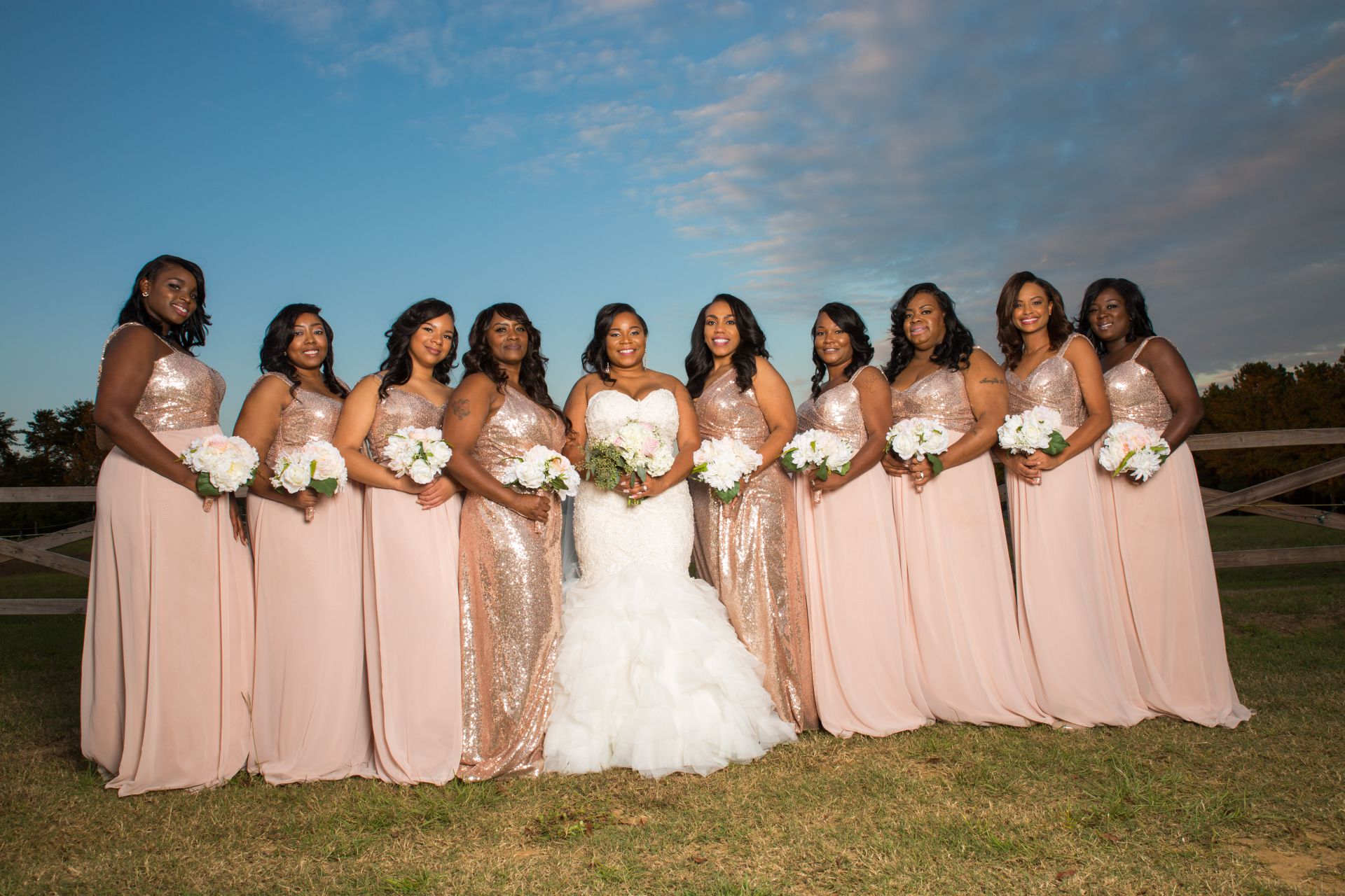 An image of bride with her bridesmaids holding flowers