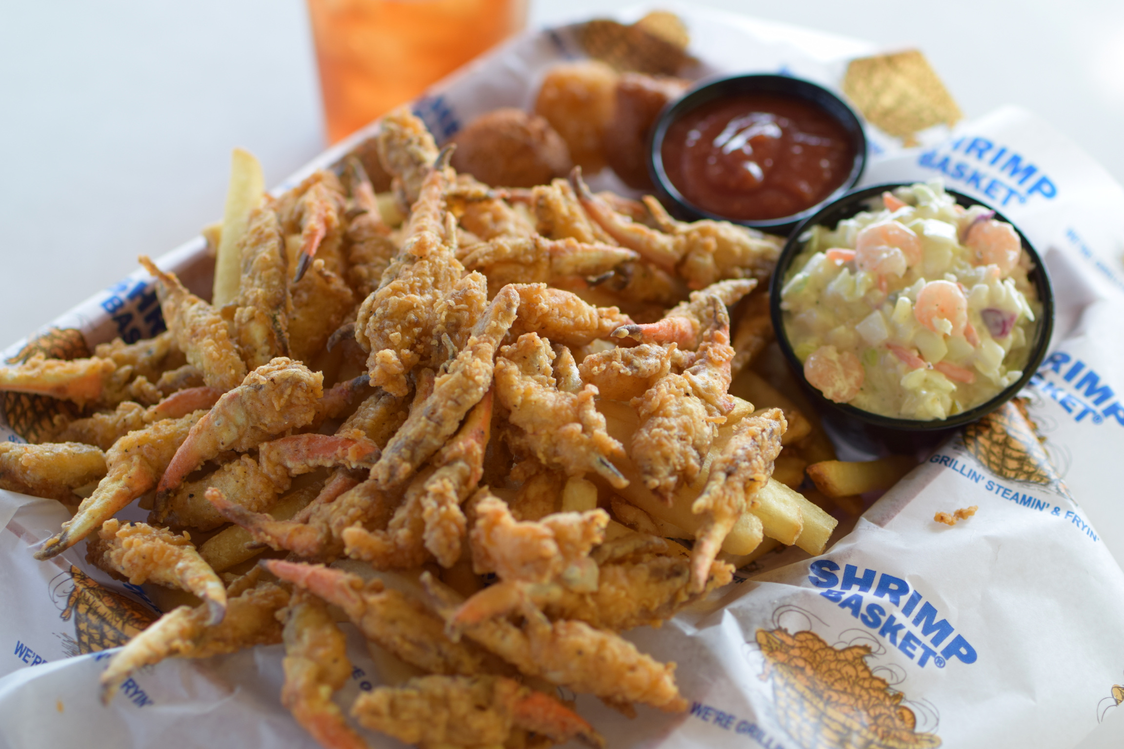 Fried crab claw basket with fries and slaw