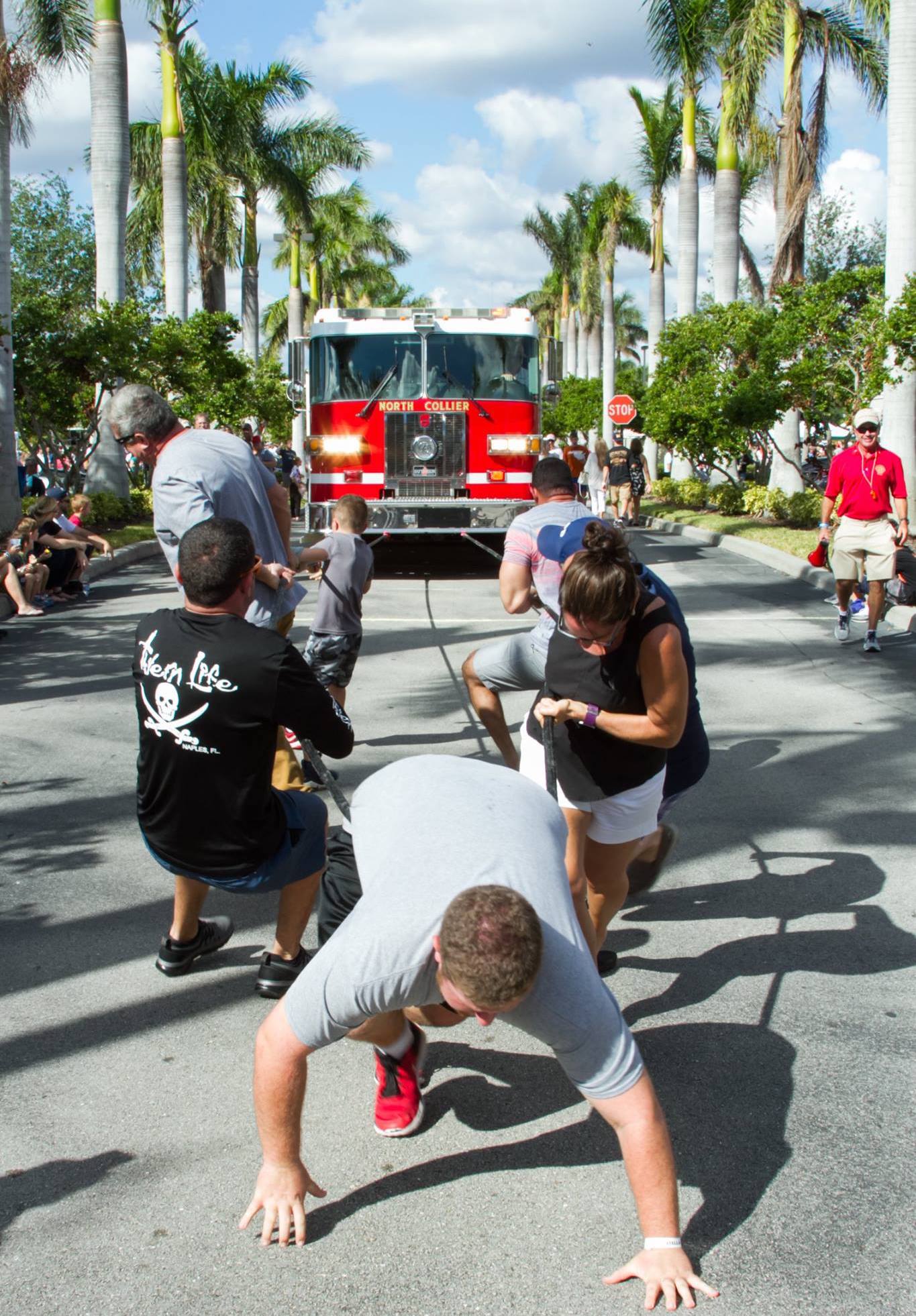 an image of people pulling a firetruck