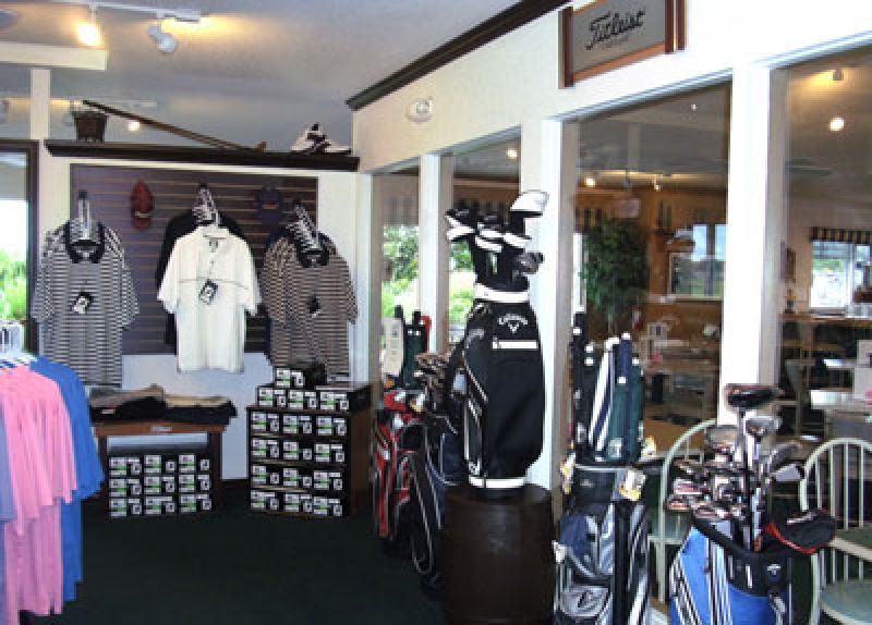 View from inside the Pro Shop showing shirts, shoes, and golf clubs