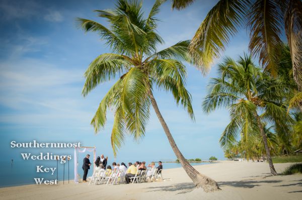 Wedding officiant performs a wedding ceremony on Smathers Beach