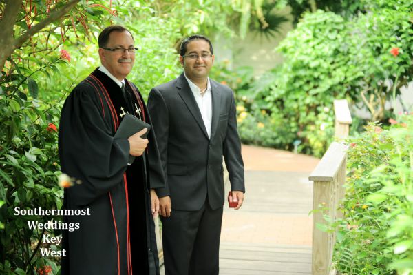 The officiant & groom wait for the bride at the start of their wedding by Southernmost Weddings