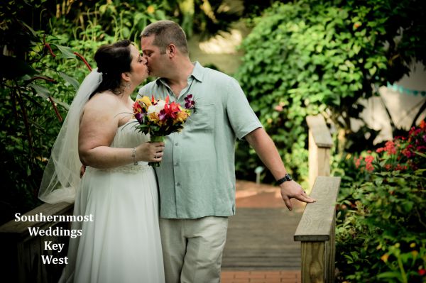 Wedding couple kisses after getting married by Southernmost Weddings