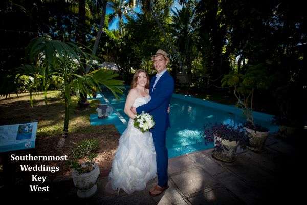 Wedding couple pose by the pool for photos by Southernmost Weddings Key West