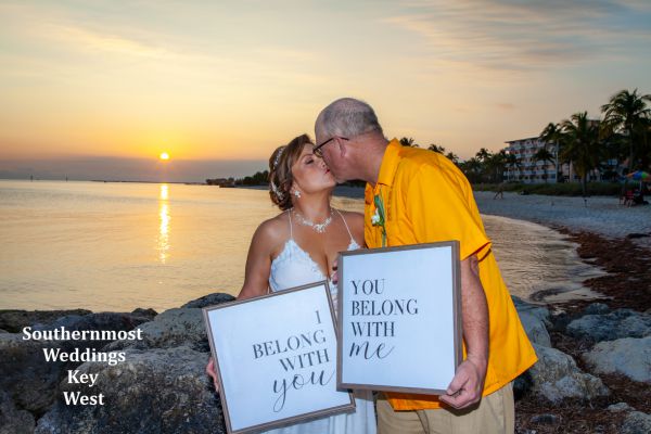 Wedding couple kiss after getting married by Southernmost Weddings on Smathers Beach in Key West, Florida