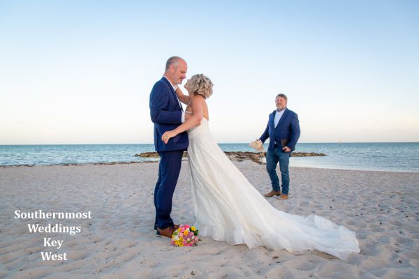 Wedding couple getting married on the beach by Southernmost Weddings