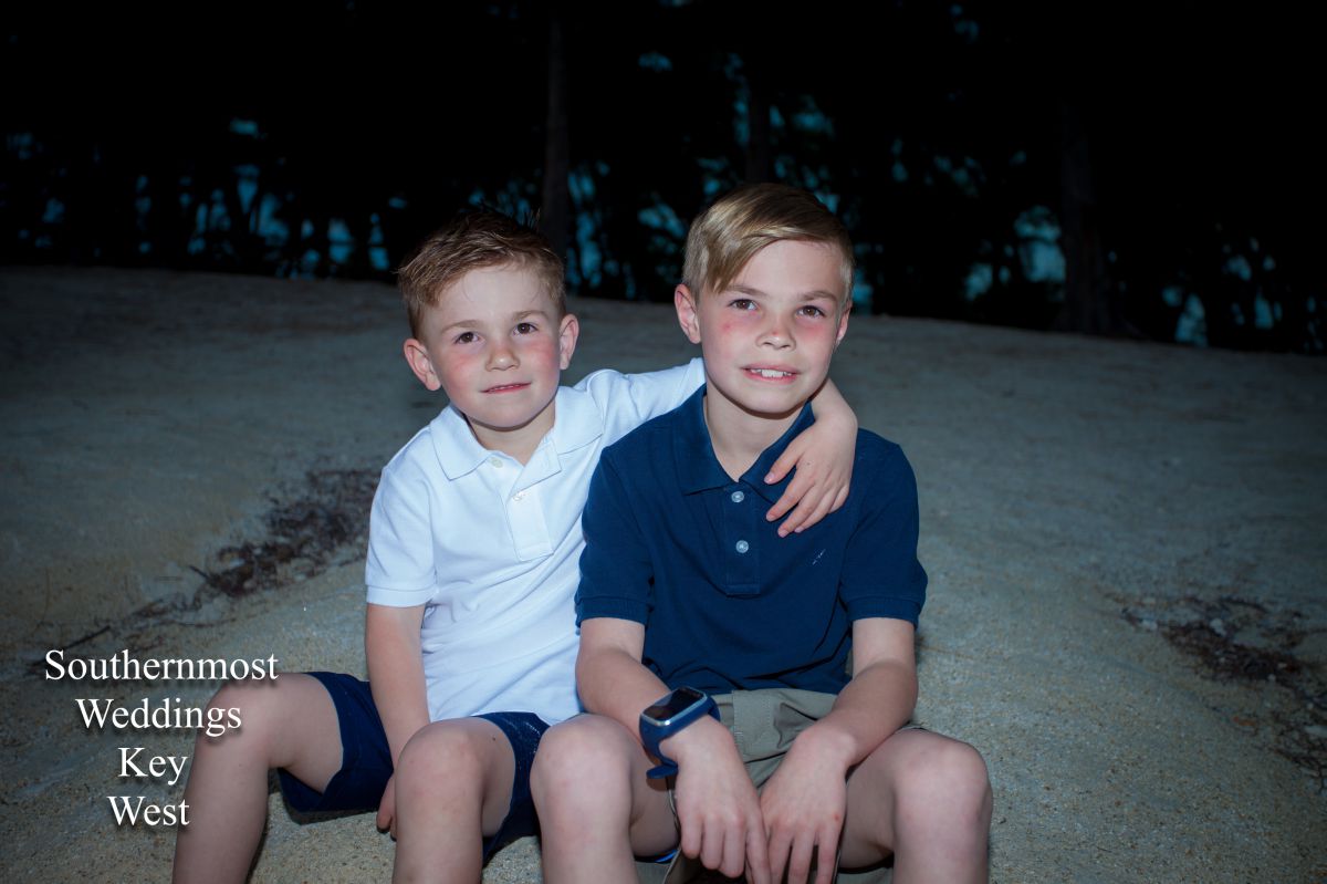 Two boys pose on the beach for photos by Southernmost Weddings Key West
