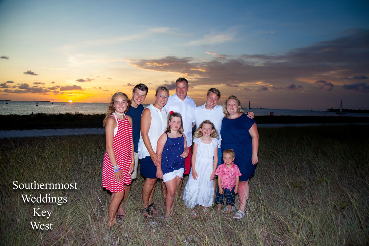 Family poses in front of the setting sun at Ft. Zachary Taylor, Image by Southernmost Weddings Key West
