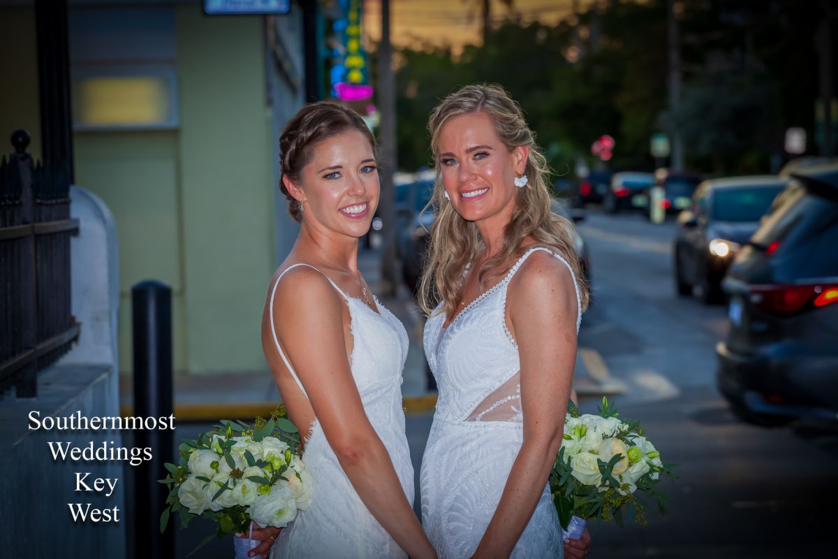 Two Brides pose for photos on Duval Street in Key West, Florida