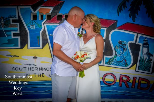 Wedding Couple pose in front of the Key West Postcard Mural