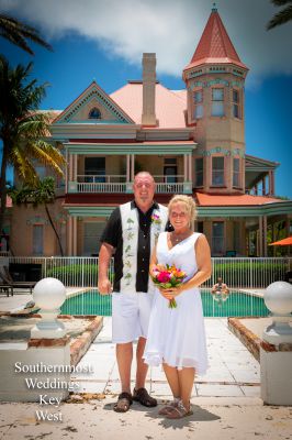 Wedding Couple pose in front of the Southernmost House Hotel, image by Southernmost Weddings Key West