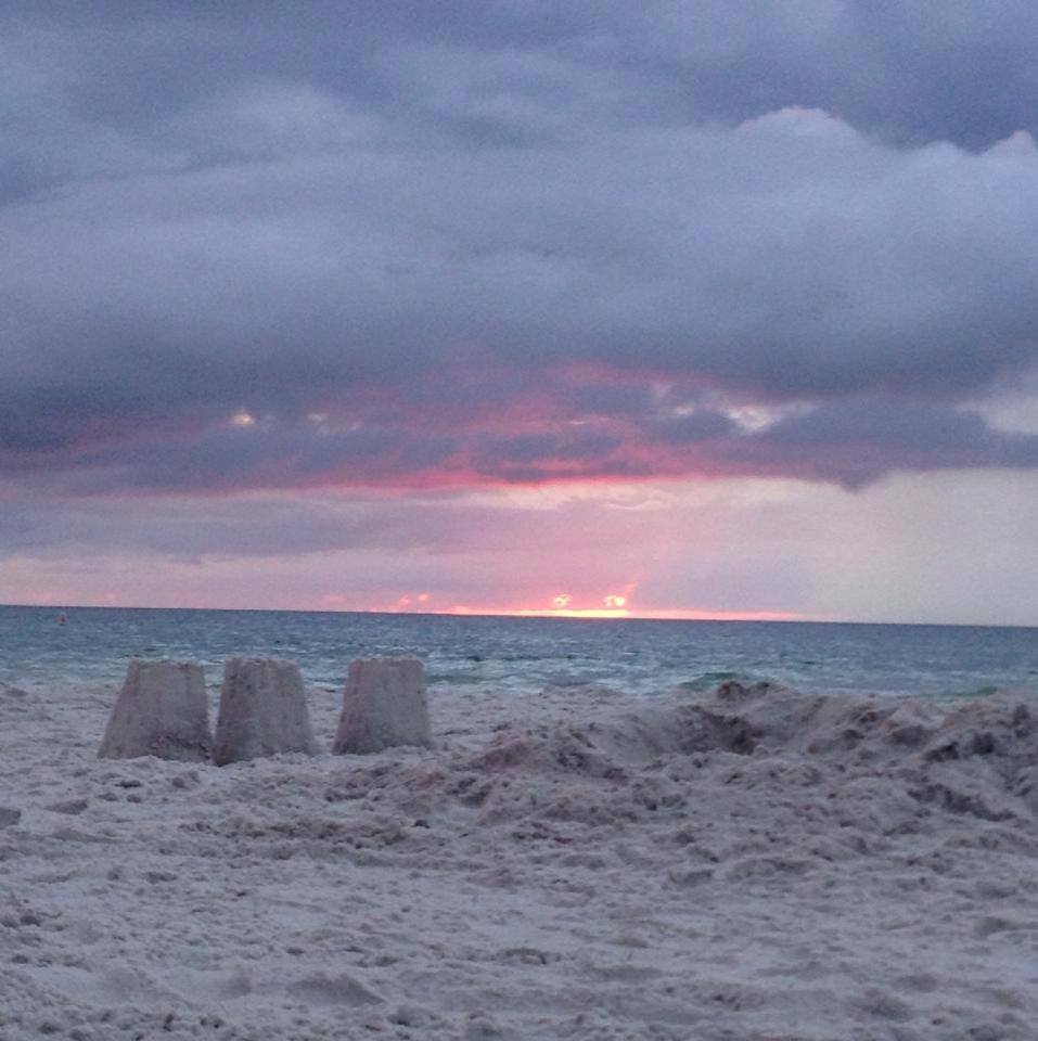 Sand castles on the beach as the sun sets