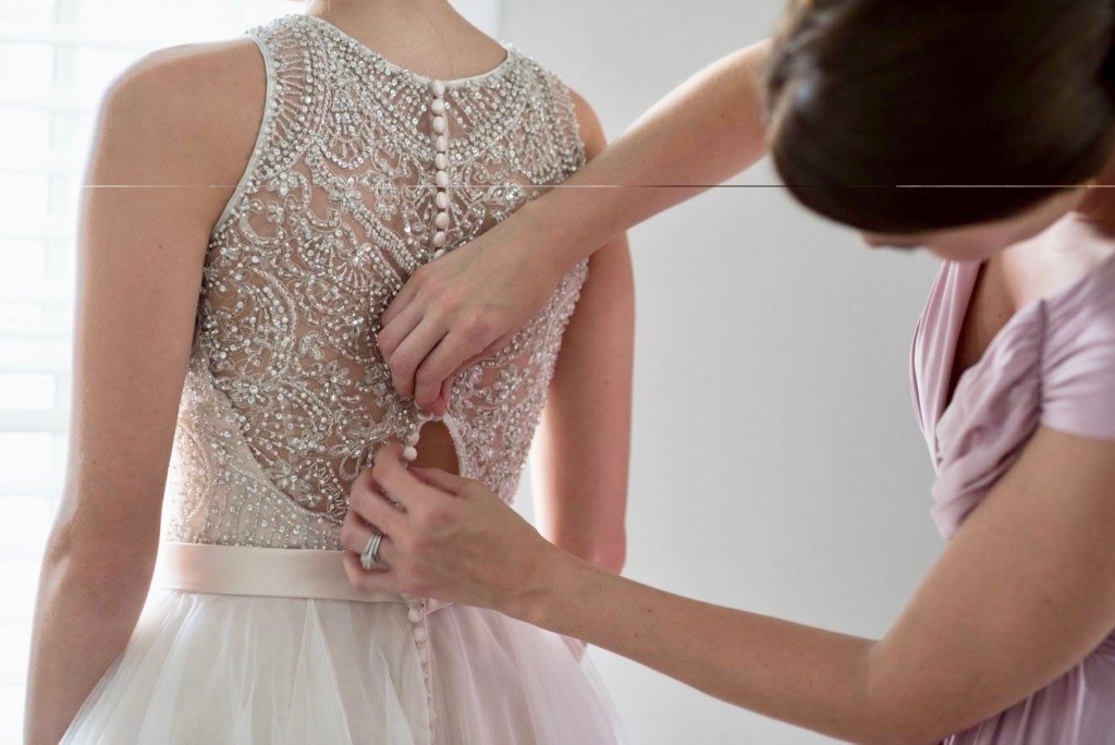 Buttoning the brides dress