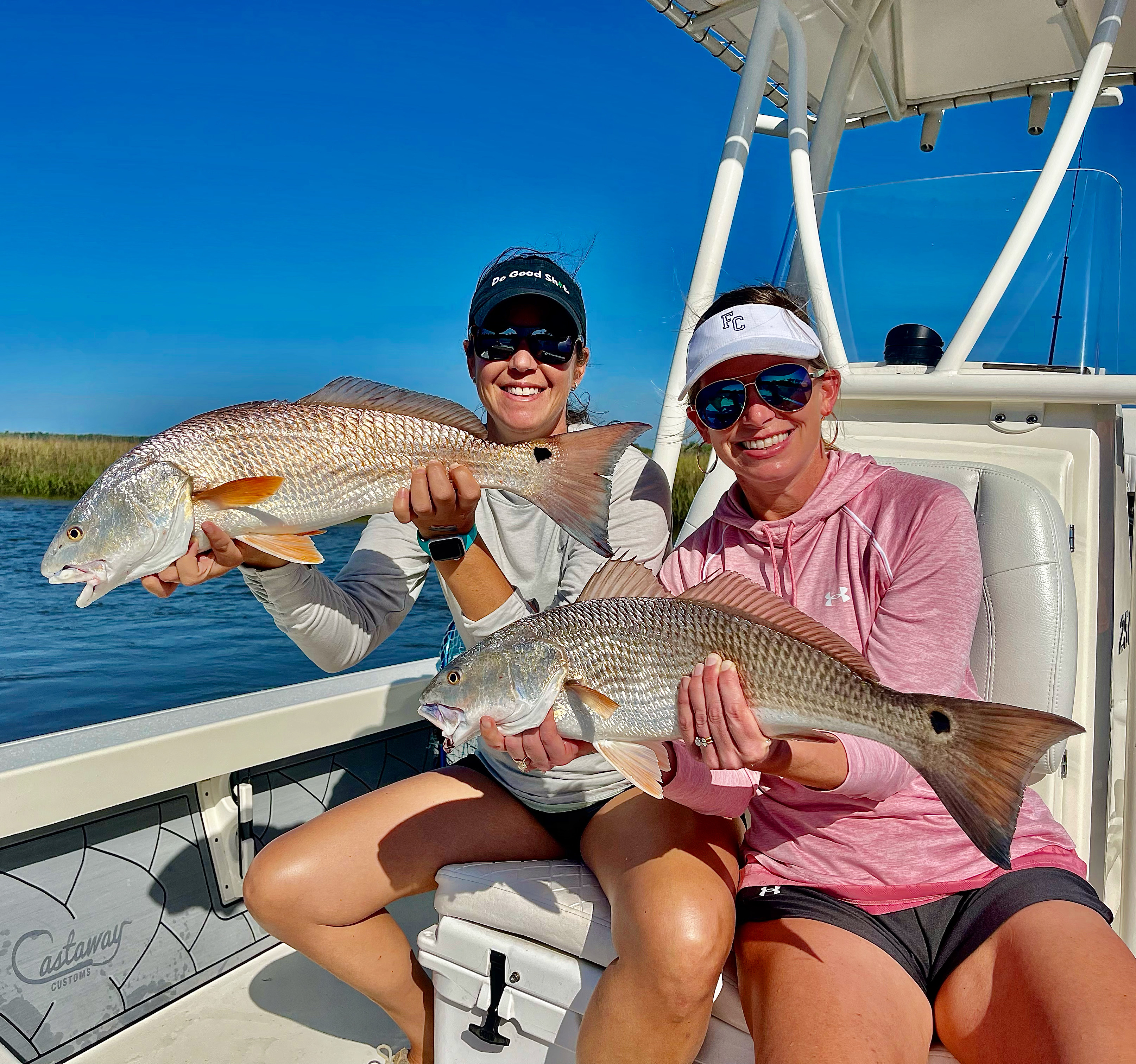 Two Ladies Holding Redfish