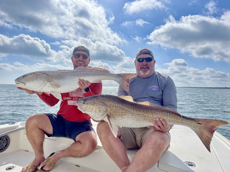 Father and Son Holding a Redfish