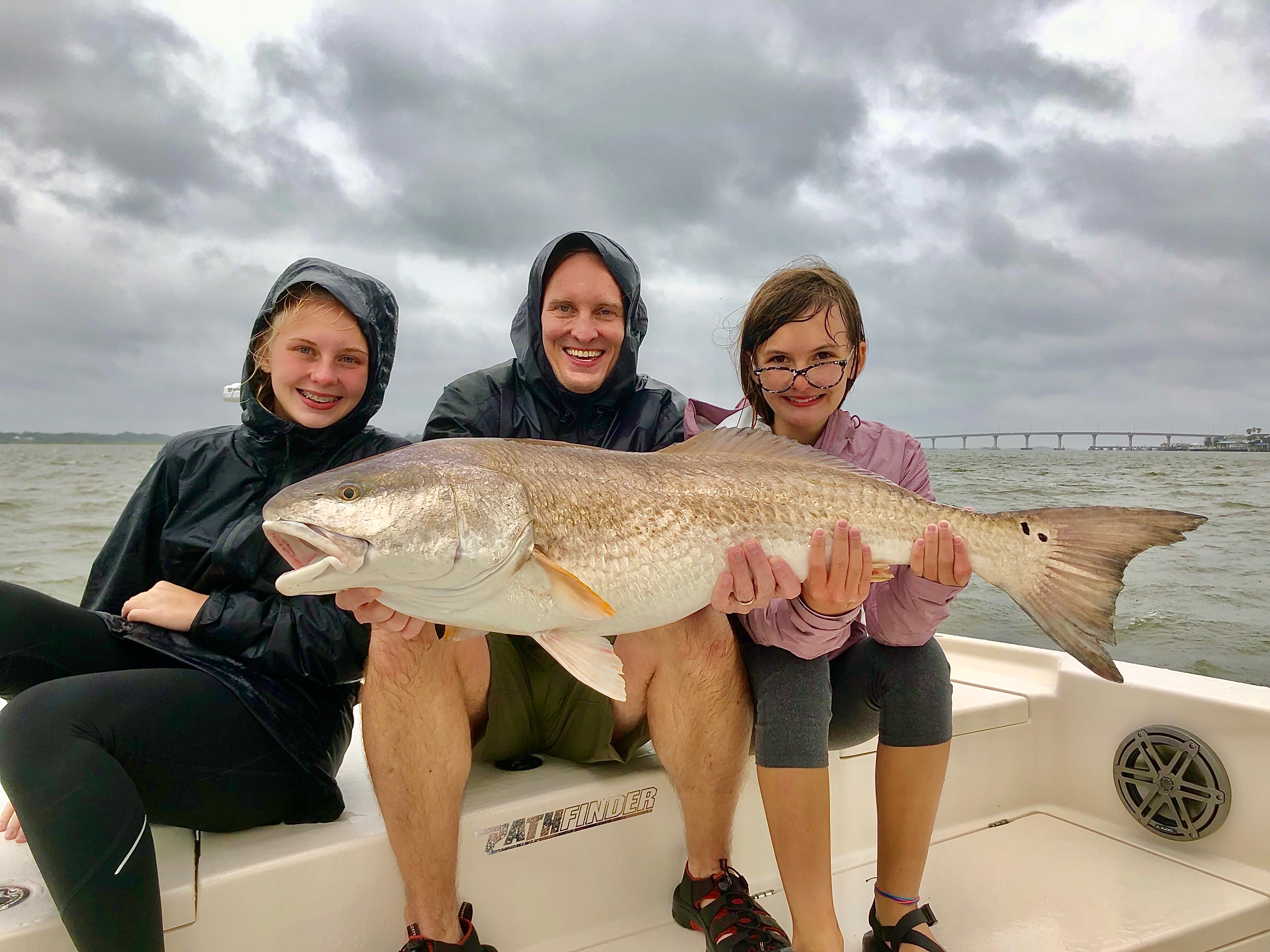Family Holding Large Redfish