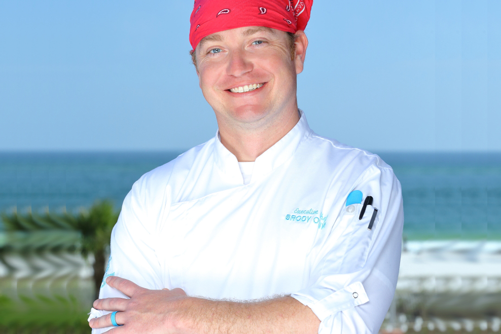 Chef with red bandana in front of ocean view