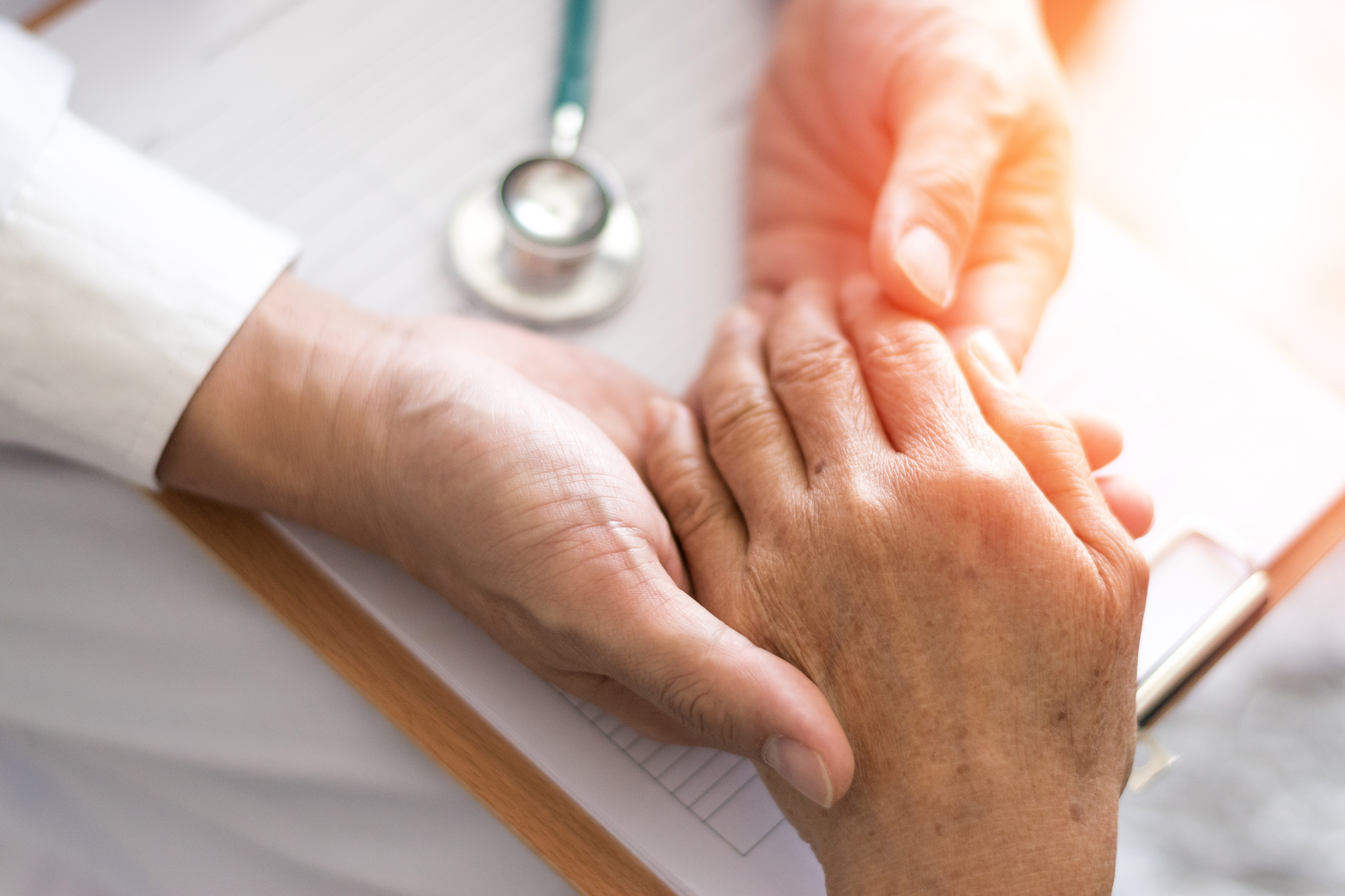 health care professional examining a patient's hand