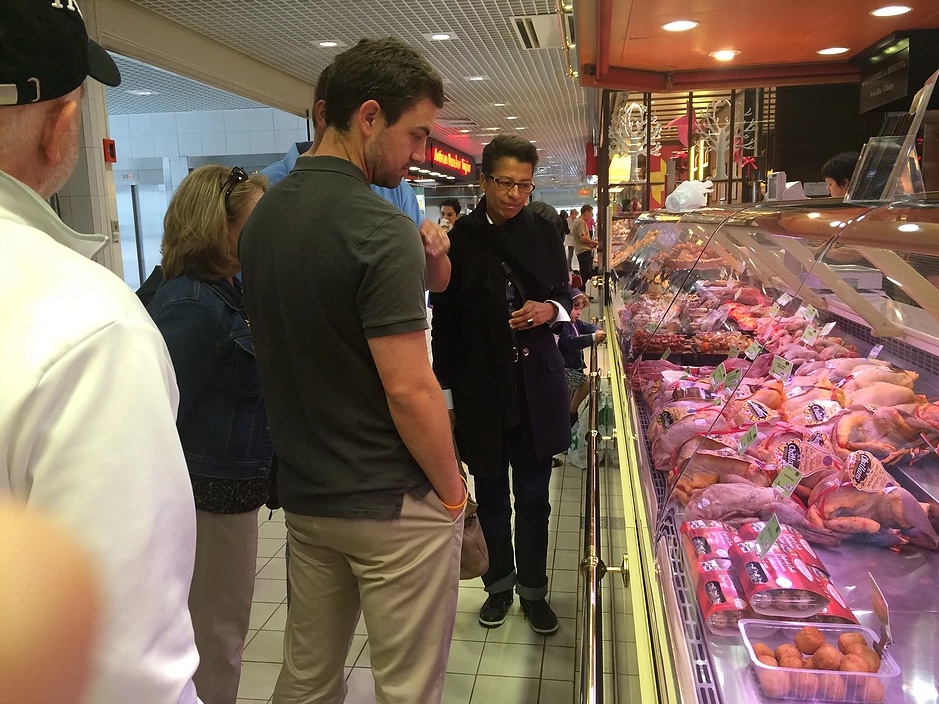 People shopping at grocery meat counter