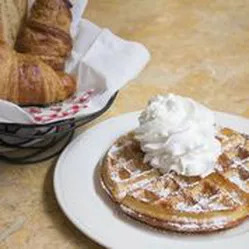 basket of croissants and a waffle