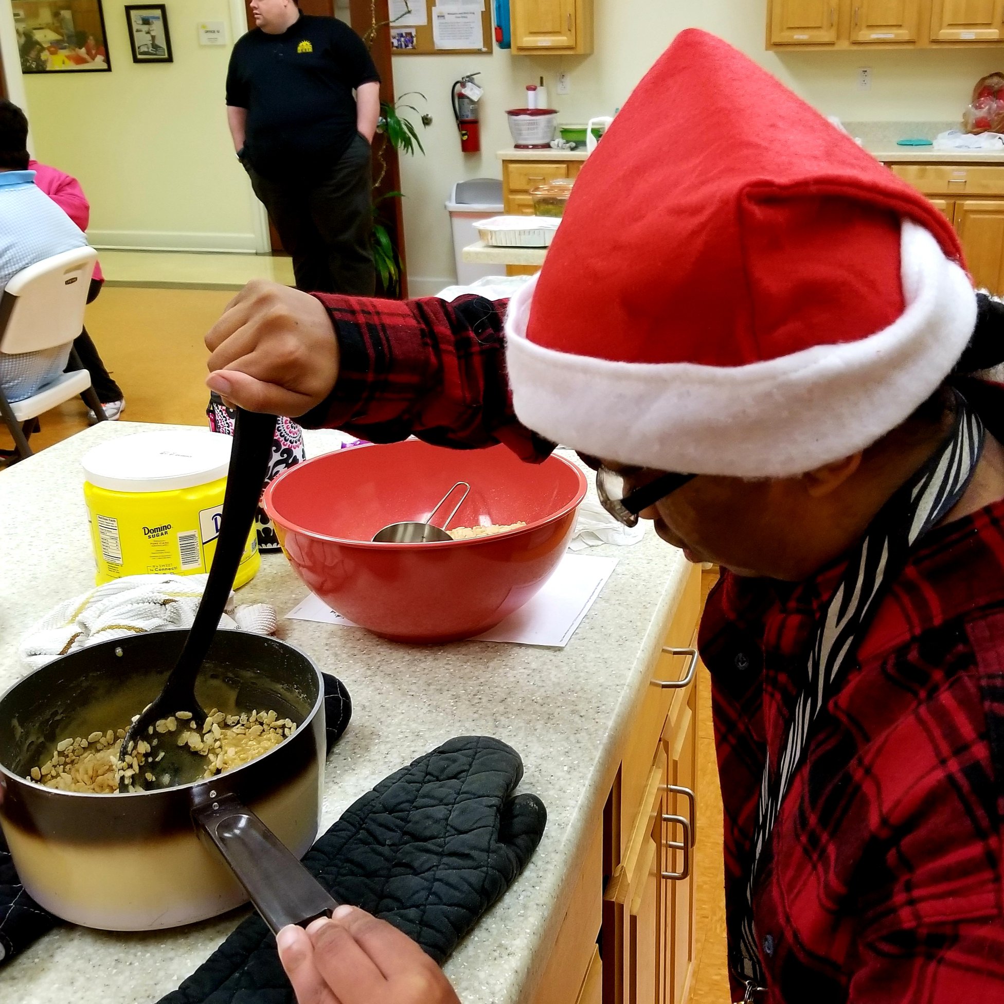 IB West client cooking while wearing a Santa Hat