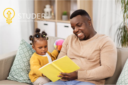 Father reading to young daughter