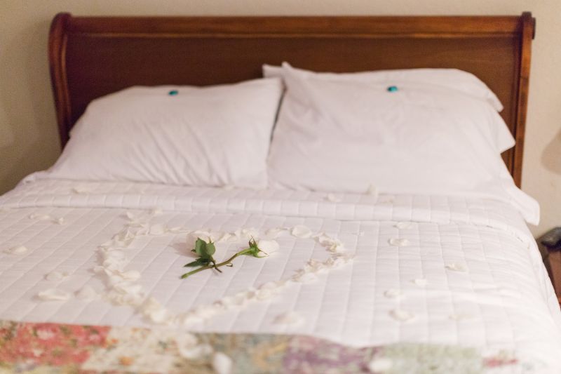 bed with a heart made of flower petals