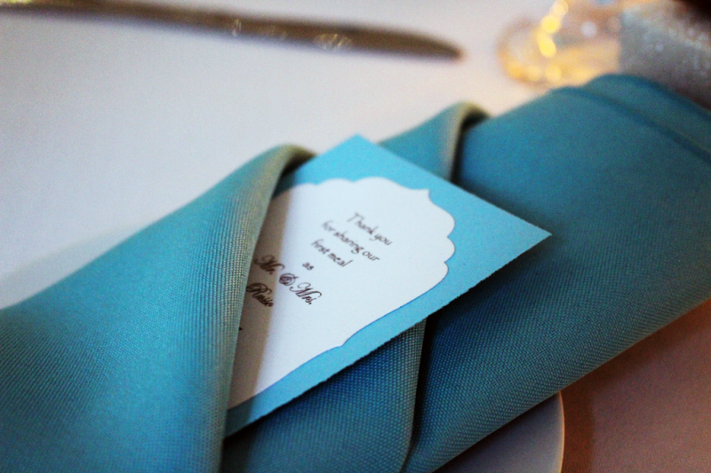 turquoise napkin with wedding announcement card