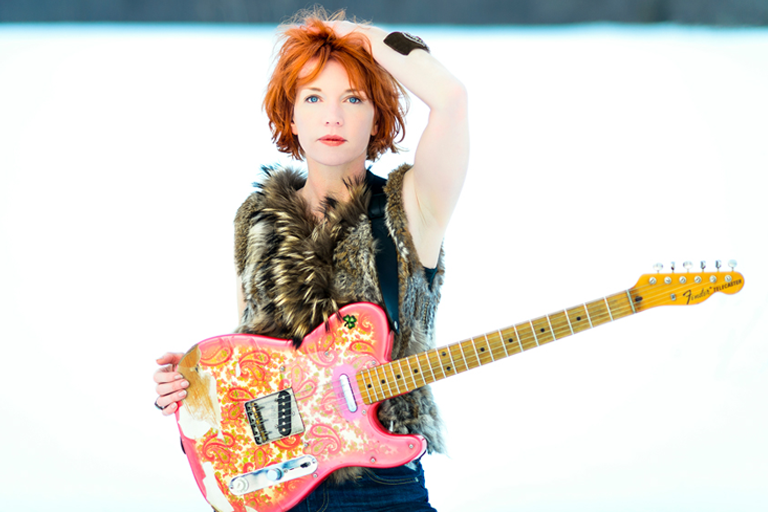 Sue Foley posing with guitar