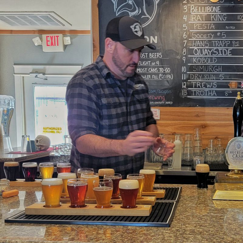 Beertender pouring beer flight samples for beer tasting 