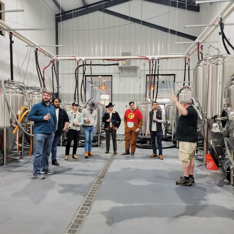 People being led on a brewhouse tour in a brewery
