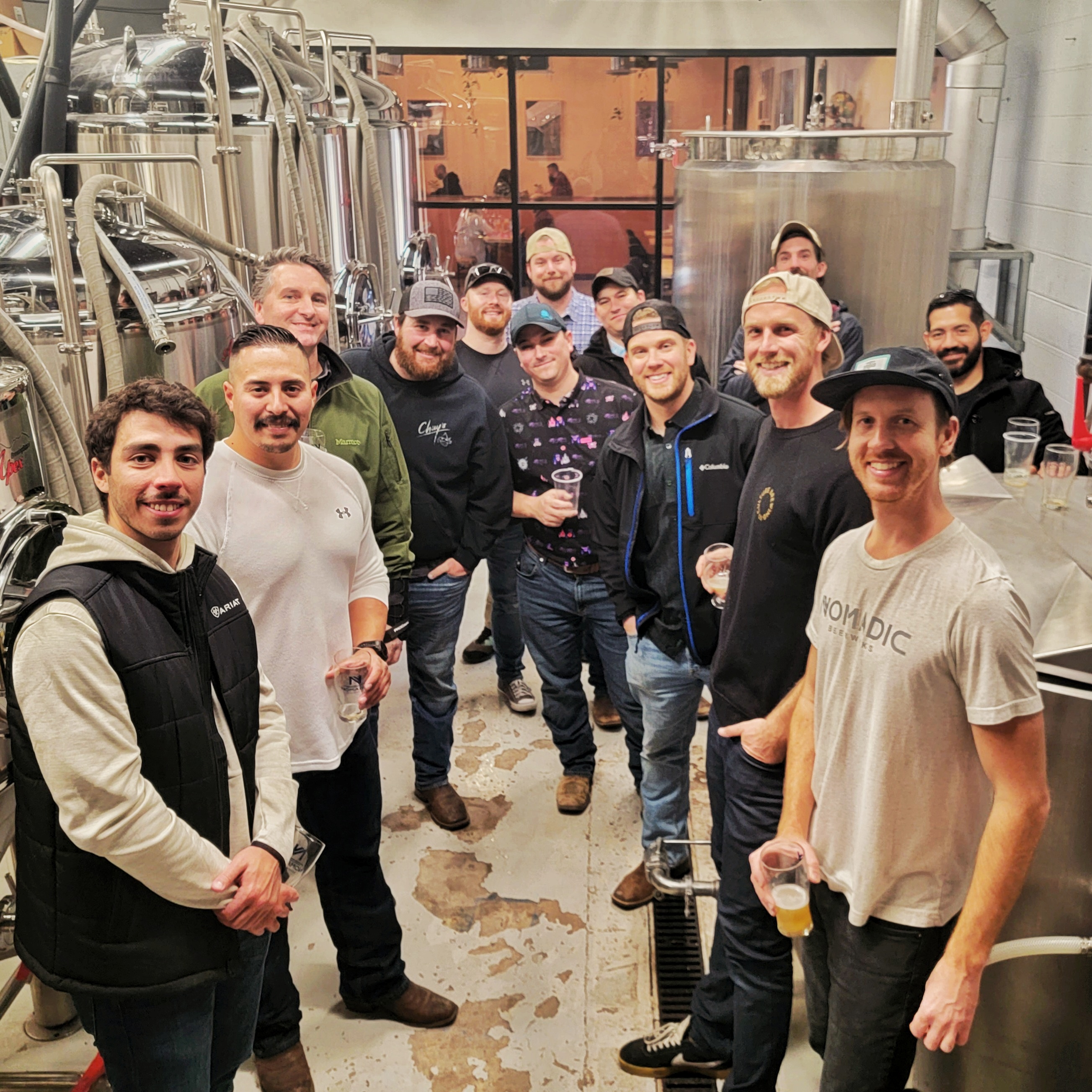 People being led on a brewhouse tour in a brewery