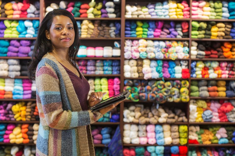 Woman in store inventorying yarn