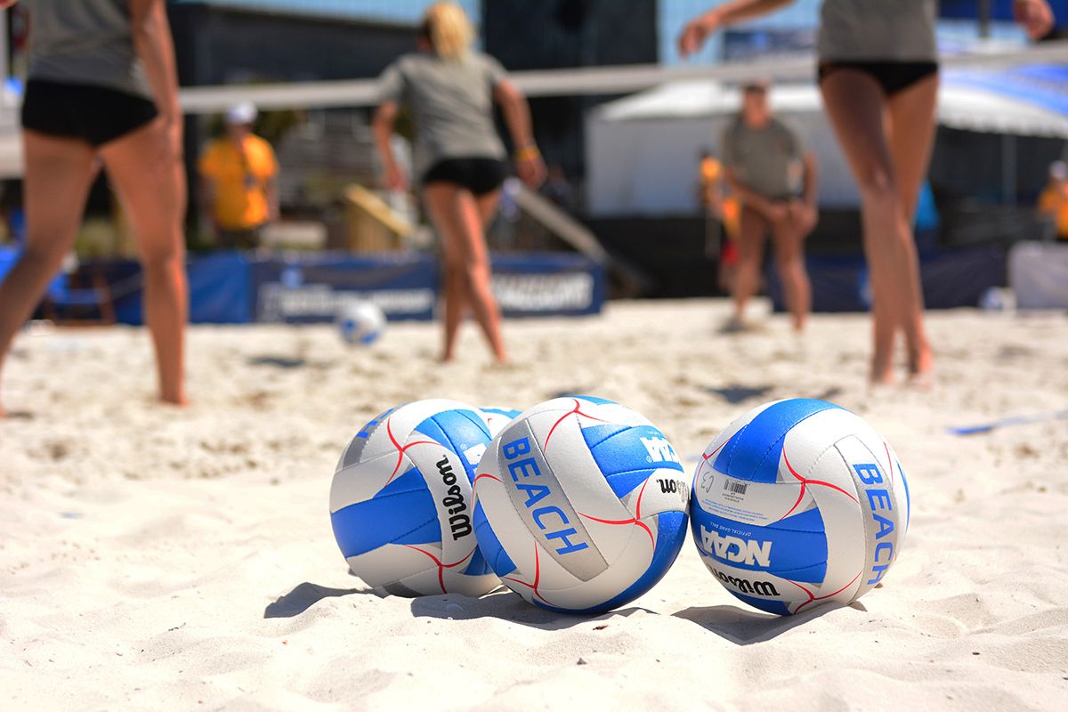 volleyballs on a sand court