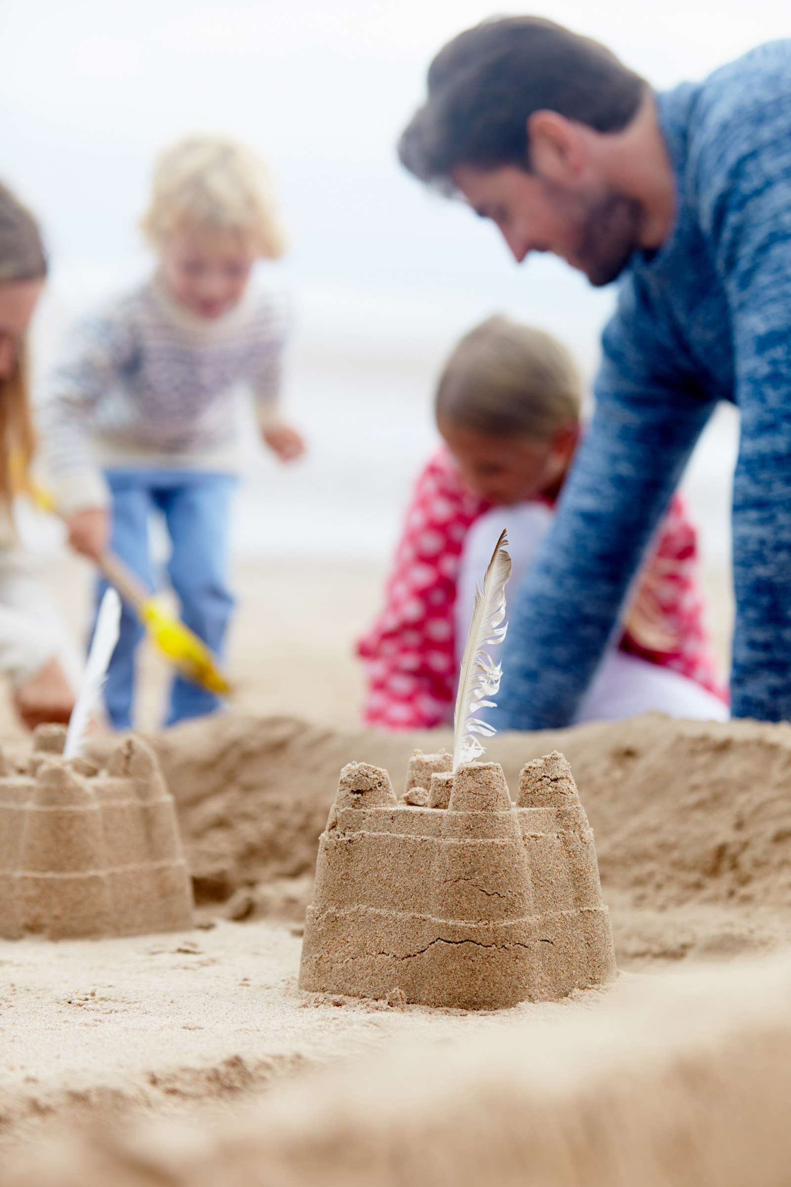 family building a sand castle