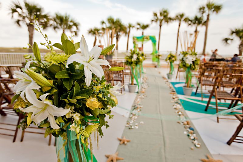 tropical decoration around wedding aisle at outdoor event