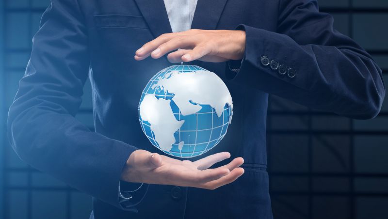 Image of person in Suit with hands above and below the globe